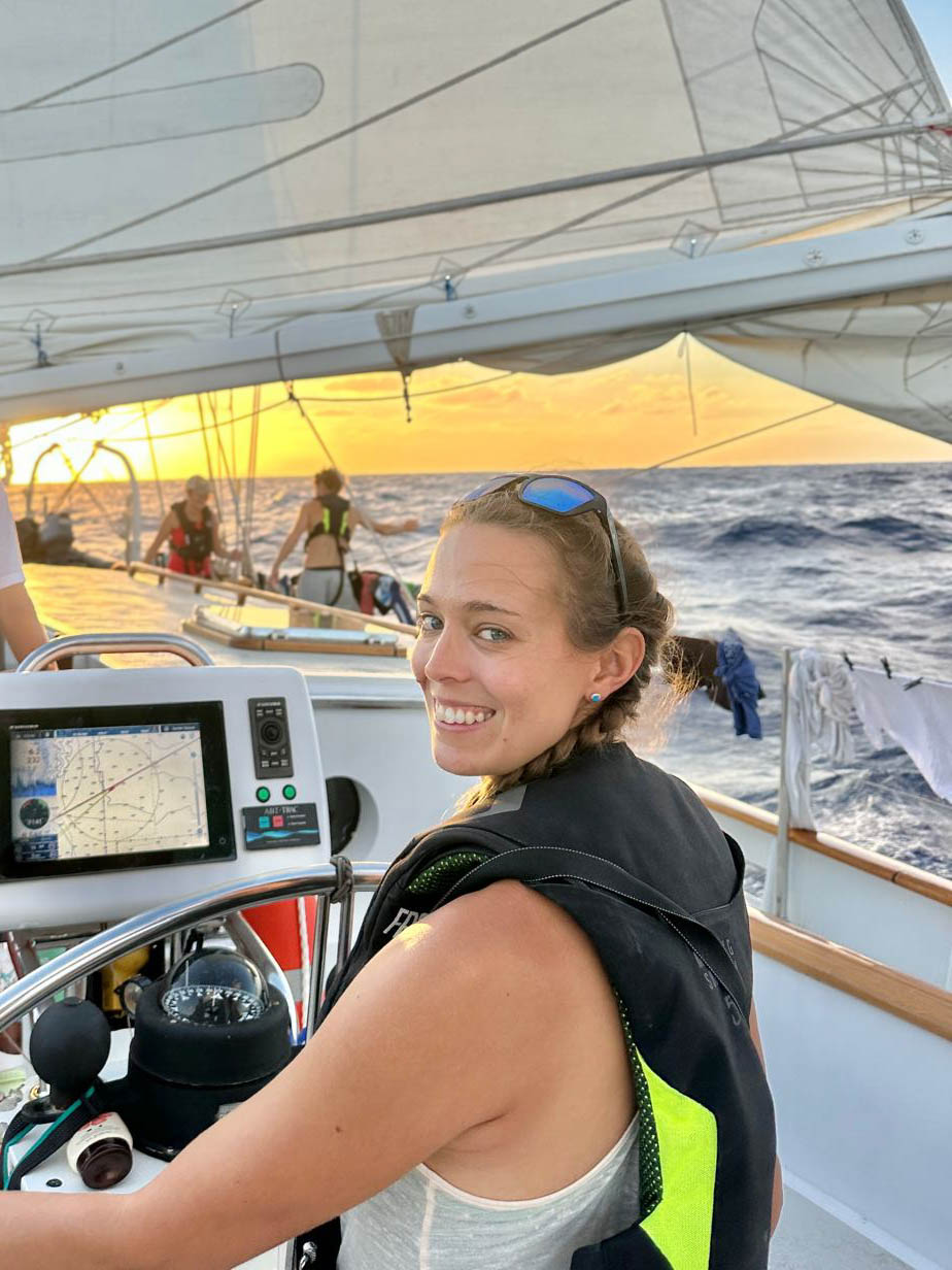Dr Michelle Carpenter at the helm of a research sailing vessel